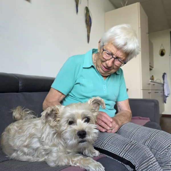 Mw Luteijn met hondje Bo op de bank - Verhalen